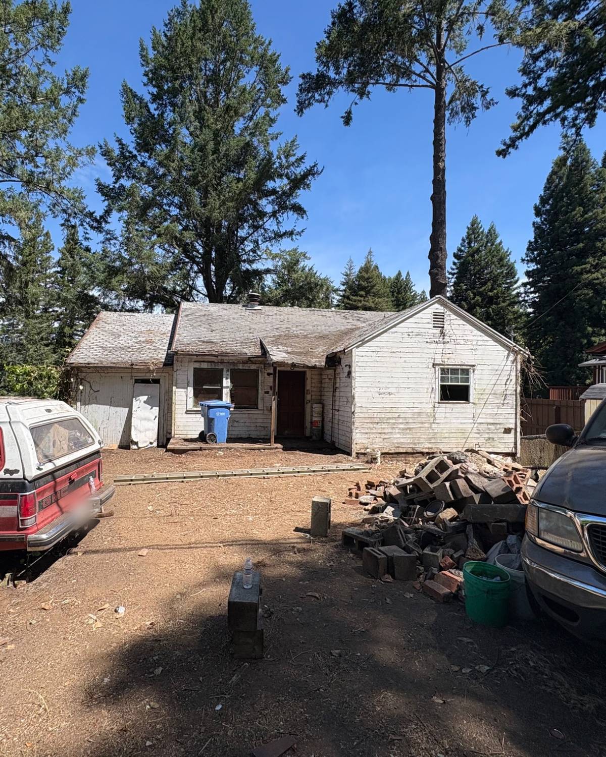 The same house after the cleanout, with the brush, appliances and yard clutter cleared from the yard